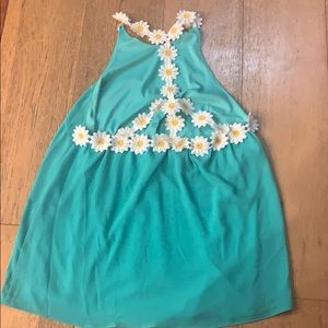 Green tank top with white daisies on the back
